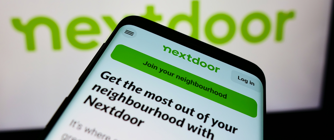 A photograph of a phone displaying the Nextdoor app